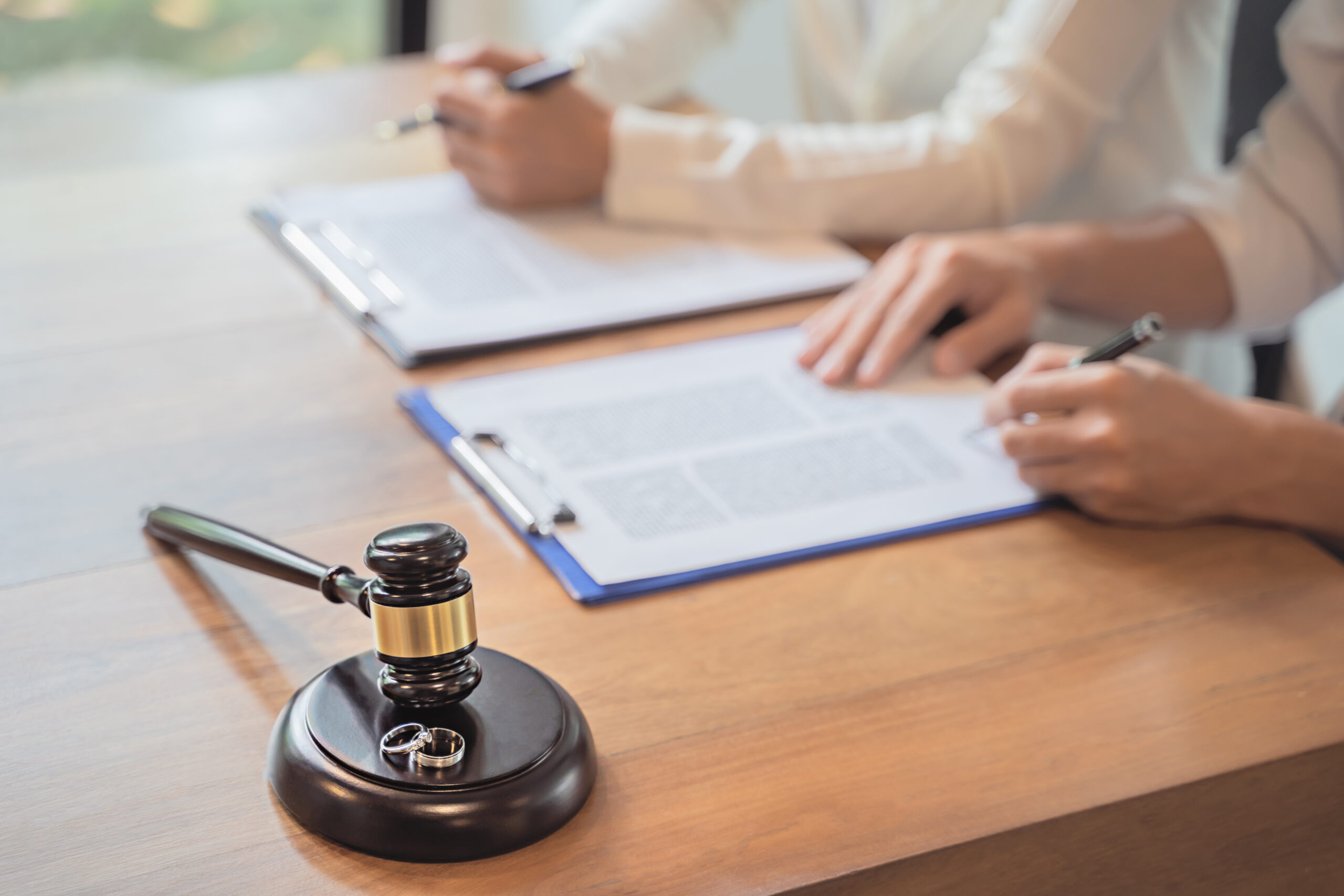 Divorce agreement. Lawyer Consultant with client in courtroom.