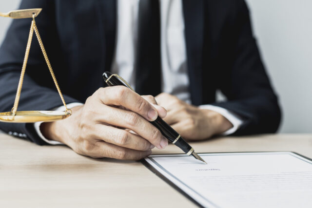 A lawyer drafting a power of attorney agreement; Who Can Override a Power of Attorney? concept image