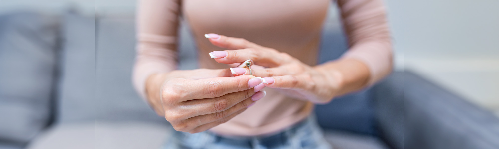 Close up of decisive woman taking off wedding ring - Tampa Divorce Lawyers concept image
