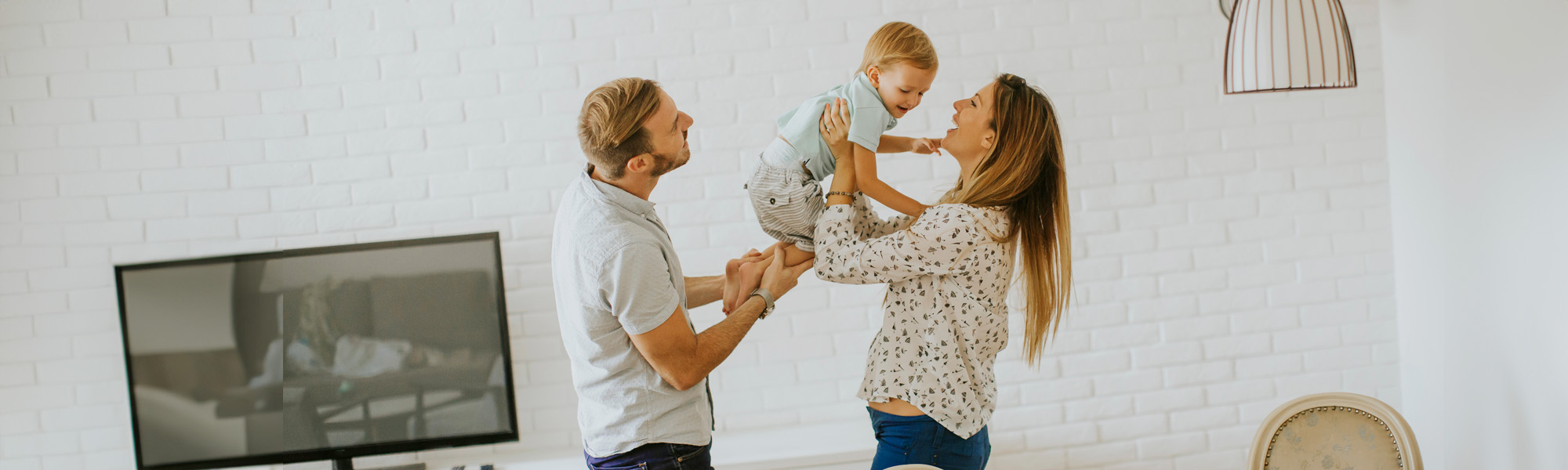 Young happy family hugging in the room - Tampa Family Lawyers concept image