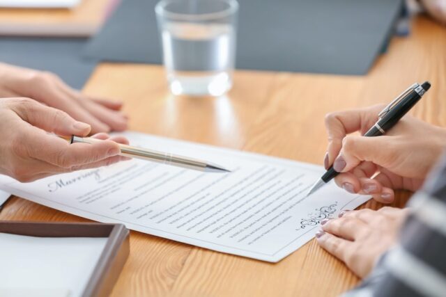 person signing a document