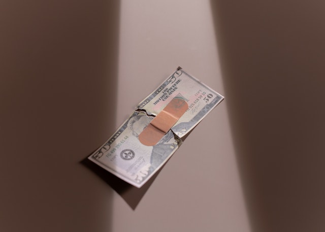 bill with bandaid on it
