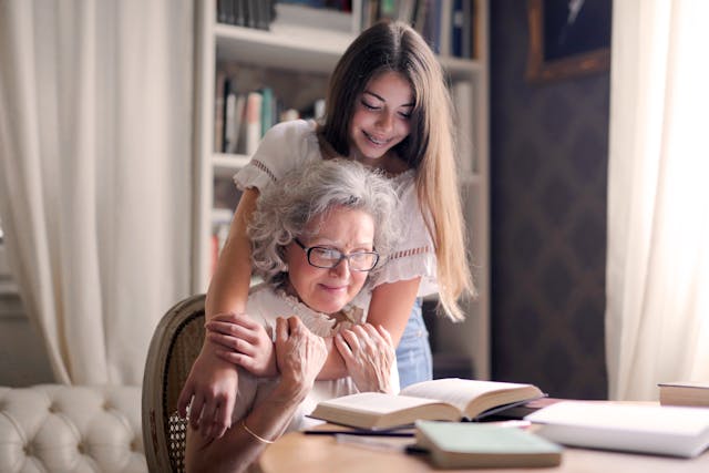 woman sitting with grandchild smiling