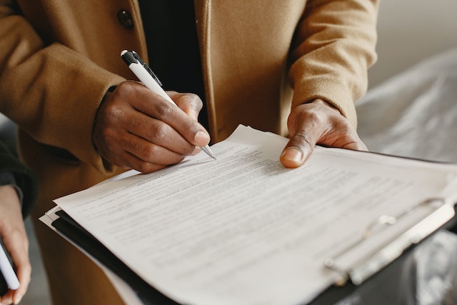 signing paper on clipboard
