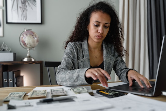 woman at desk doing calculations