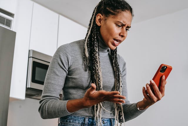 stressed woman looking at phone