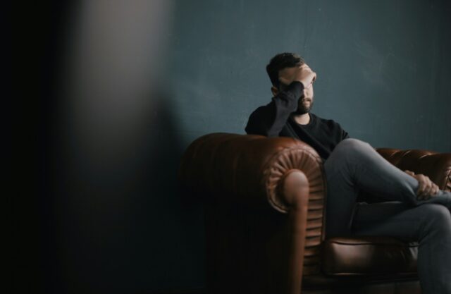 stressed man on couch