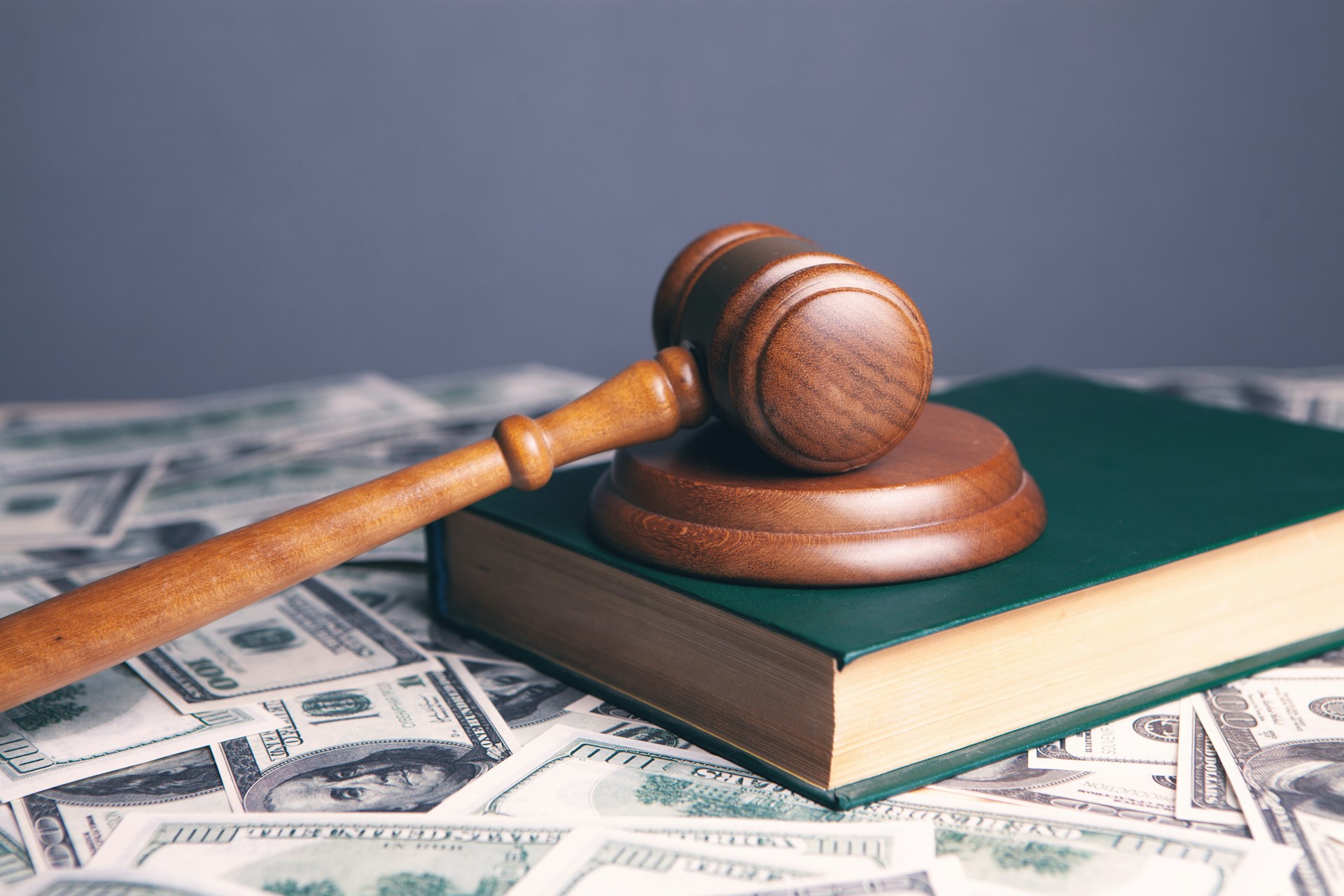 stack of money on gavel; What Can I Do if I Believe My Ex is Concealing Assets? concept image