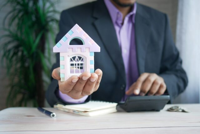 hand holding a miniature home